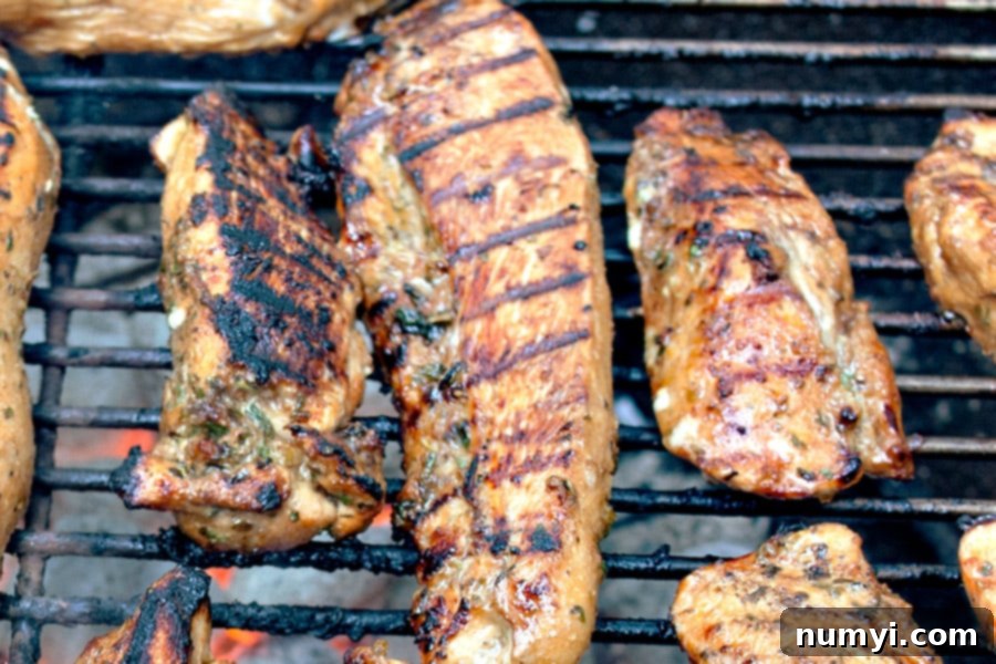 Best Ever Grilled Chicken Marinade on chicken grilling on a Weber grill.