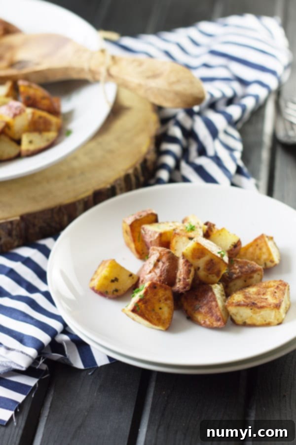 Roasted potatoes ready to be served, with more in the background