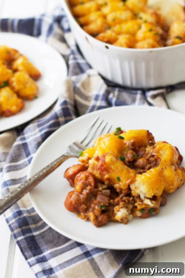 A close-up of a plate brimming with Chili Cheese Tater Tot Casserole, ready to be enjoyed.