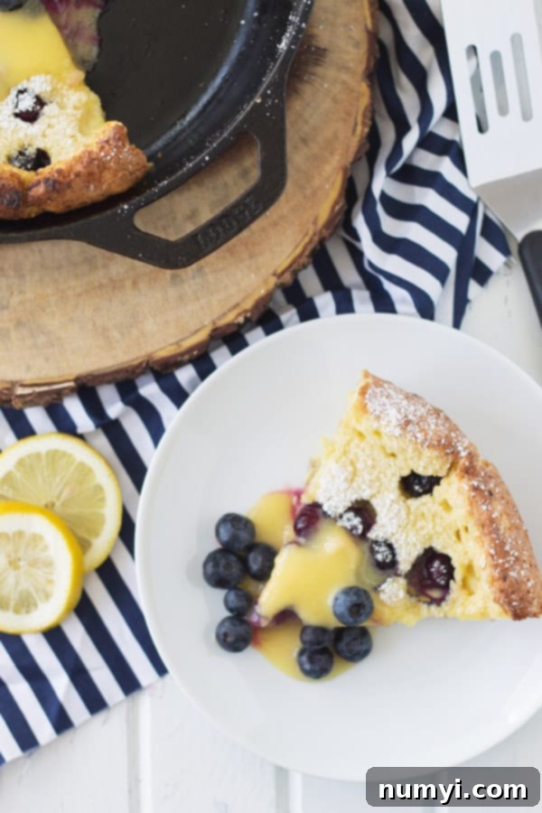 A second close-up view of the Blueberry Dutch Baby with lemon curd, highlighting the fresh blueberries and creamy texture.