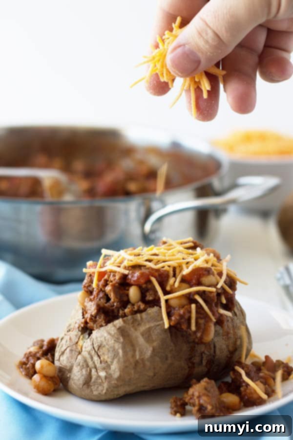 Fluffy baked potato loaded with savory taco meat, cheese, and fresh toppings.
