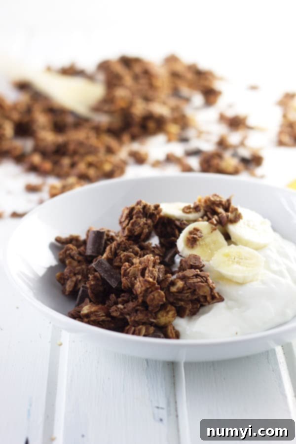 Delicious chocolate peanut butter granola chunks on a white baking sheet, showcasing their rich color and texture