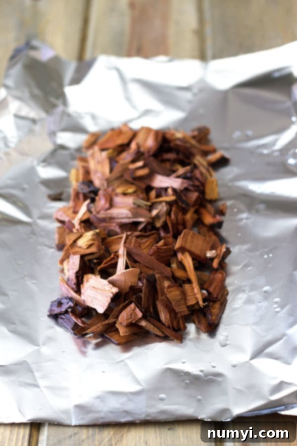 Seasoned raw pork chops, prepped for the quick smoking process on the grill.