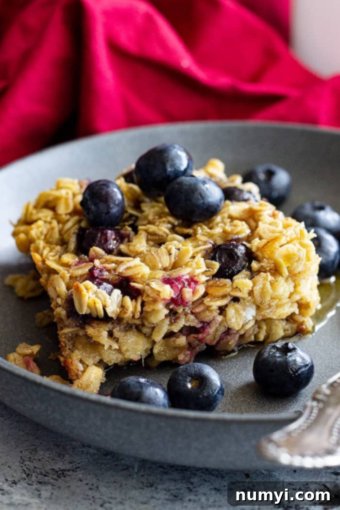 A dish of baked oatmeal topped with fresh blueberries.