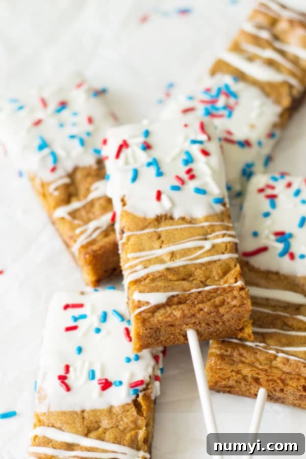 Fourth of July Cookie Sticks -a chewy chocolate chip cookie bar dipped in white chocolate then sprinkled with red, white and blue sprinkles! | www.countrysidecravings.com