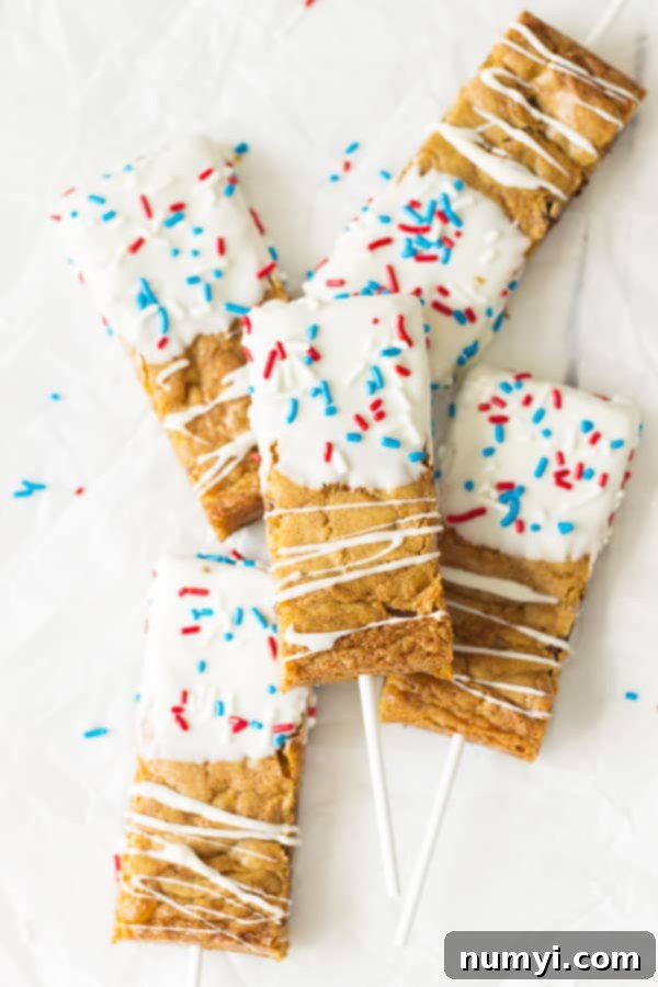 Fourth of July Cookie Sticks -a chewy chocolate chip cookie bar dipped in white chocolate then sprinkled with red, white and blue sprinkles! | www.countrysidecravings.com