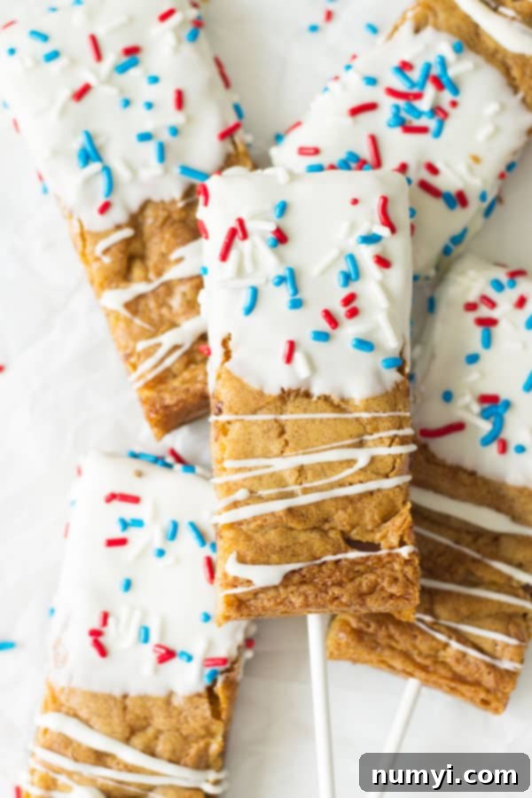 Fourth of July Cookie Sticks -a chewy chocolate chip cookie bar dipped in white chocolate then sprinkled with red, white and blue sprinkles! | www.countrysidecravings.com