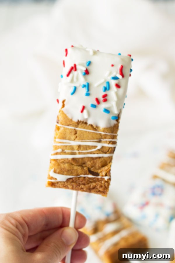 Fourth of July Cookie Sticks -a chewy chocolate chip cookie bar dipped in white chocolate then sprinkled with red, white and blue sprinkles! | www.countrysidecravings.com