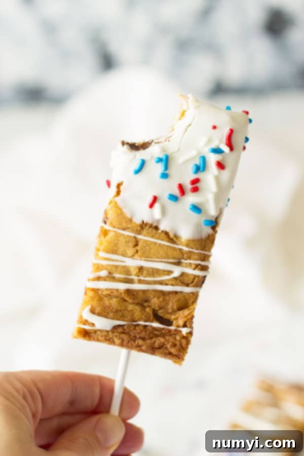 Fourth of July Cookie Sticks -a chewy chocolate chip cookie bar dipped in white chocolate then sprinkled with red, white and blue sprinkles! | www.countrysidecravings.com