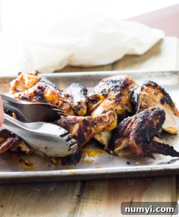 Two halves of Applewood Grill Smoked Chicken, showcasing the perfect golden skin and juicy texture, ready for carving.