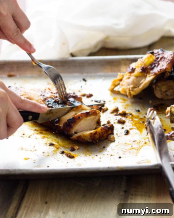 Close-up of a halved Applewood Grill Smoked Chicken on the grill, with applewood smoke chips contributing to its rich flavor.