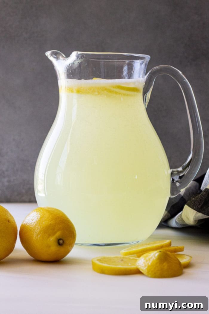 Sunshine in a Glass 5 A pitcher of freshly made homemade lemonade, garnished with lemon slices.
