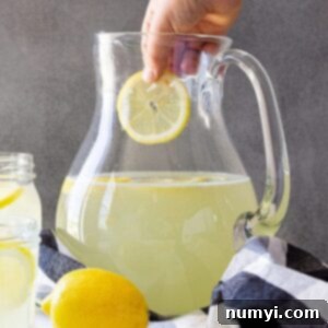 Sunshine in a Glass 7 Dropping a cut lemon into the lemonade.