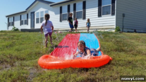Kids enjoying a water slide on a summer day