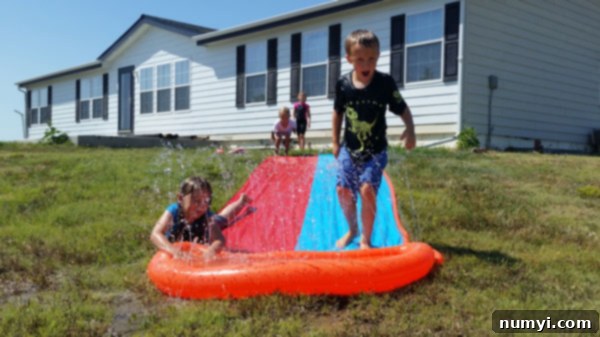 Children playing happily on a water slide