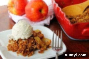 A top-down view of a baked apple crisp with a golden, oat-filled topping.
