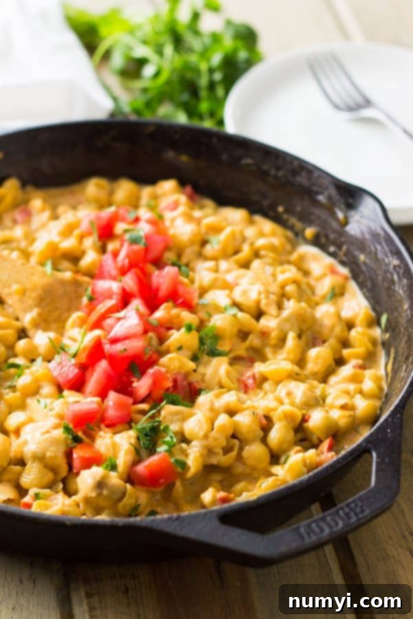 Closeup of cheesy One Pot Southwestern Chicken Macaroni and Cheese in a skillet