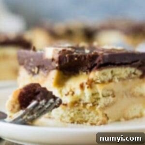 Twix Icebox Cake sliced to show layers of pudding, cookies, and caramel