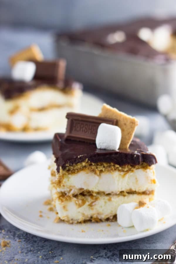 An easy S'mores Ice Box Cake recipe made with graham crackers, marshmallow filling and topped with chocolate ganache! | www.countrysidecravings.com