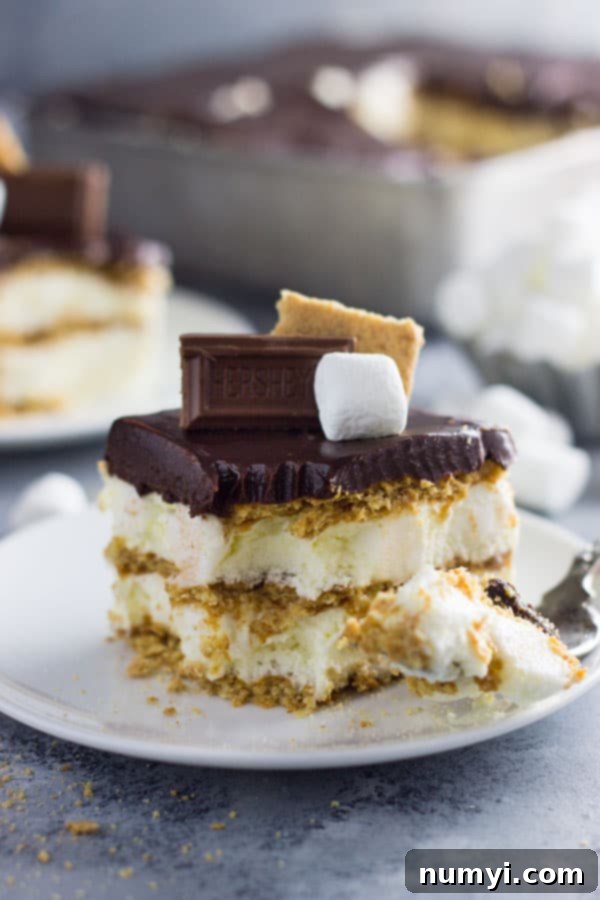 An easy S'mores Ice Box Cake recipe made with graham crackers, marshmallow filling and topped with chocolate ganache! | www.countrysidecravings.com