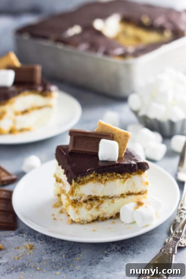 An easy S'mores Ice Box Cake recipe made with graham crackers, marshmallow filling and topped with chocolate ganache! | www.countrysidecravings.com