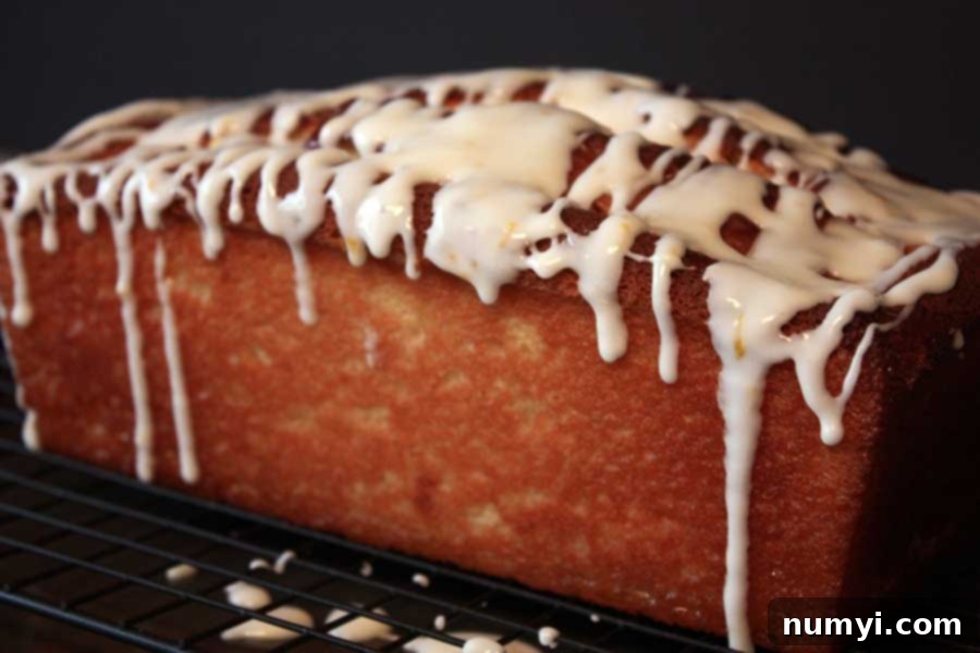 The finished Meyer Lemon Loaf, beautifully glazed, resting on a wire rack, ready to be sliced and enjoyed.
