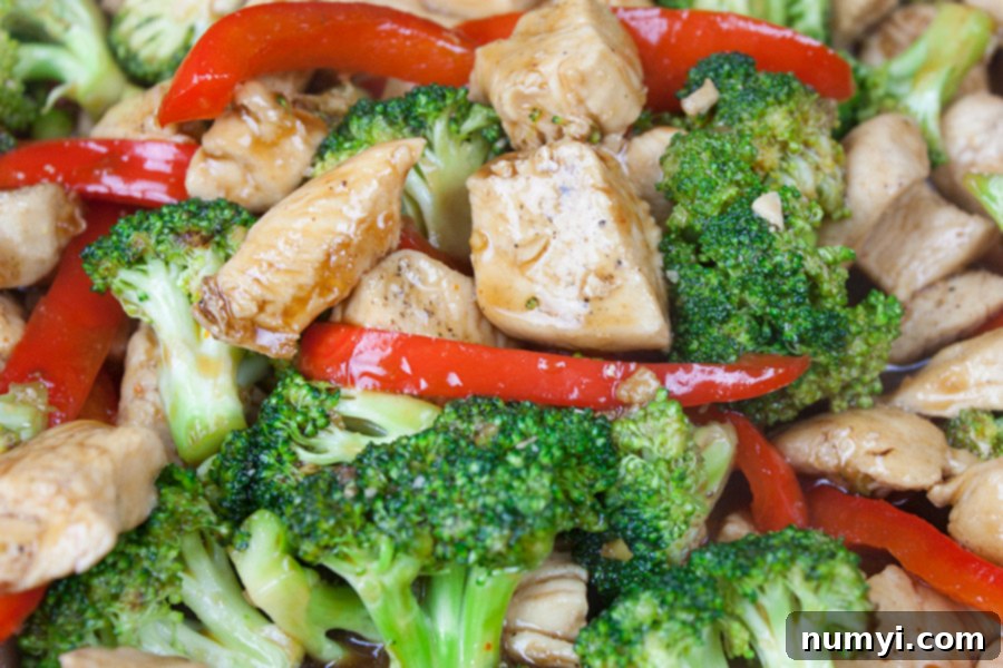 closeup of Easy Chicken and Broccoli Stir Fry with thick, glossy sauce