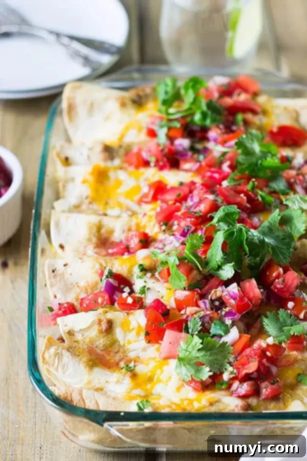 overview: breakfast enchilada casserole with fresh cilantro and pico de gallo garnish