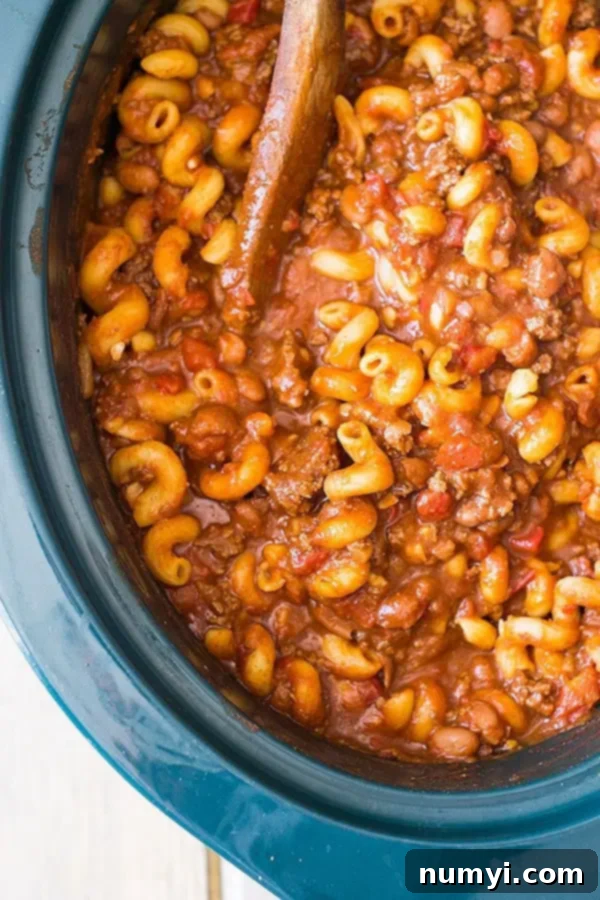 Overhead view of slow cooker chili mac, ready to serve in the crockpot.