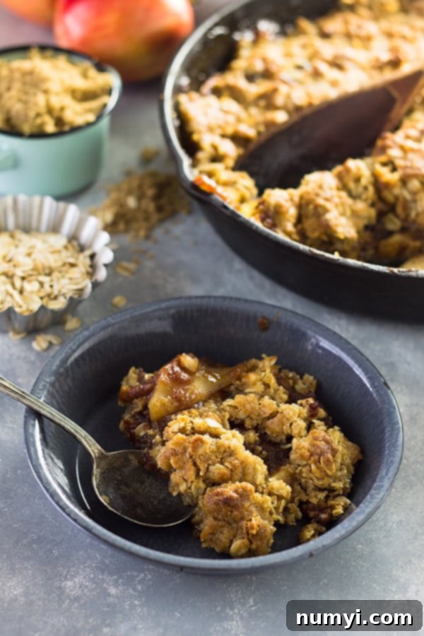 A spoonful of Easy Apple Butter Apple Crisp, highlighting the soft apple filling and the crispy streusel topping.