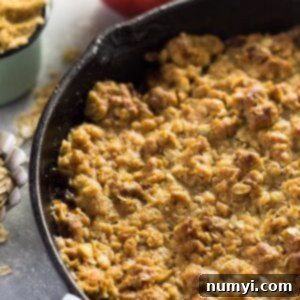 A small image of the Easy Apple Butter Apple Crisp in a cast iron skillet.
