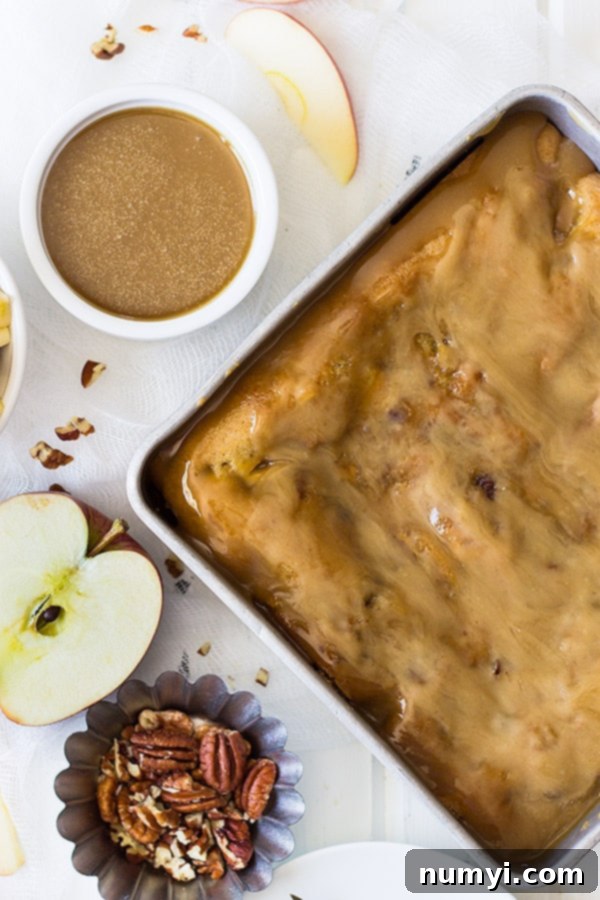 This Caramel Apple Pecan Cake is filled with tender apples, crunchy pecans and topped with a luscious caramel frosting! | www.countrysidecravings.com