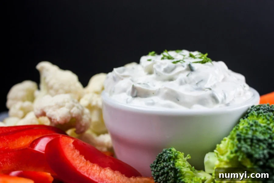 Fresh Herb Vegetable Dip with various vegetables around it on a platter.