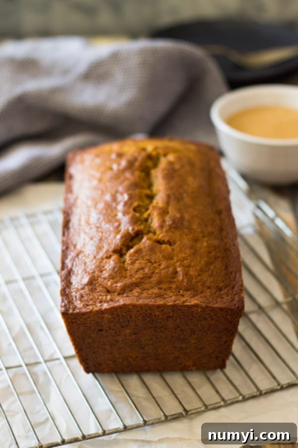 Whole Pumpkin Bread loaf drizzled generously with Cream Cheese Caramel Icing