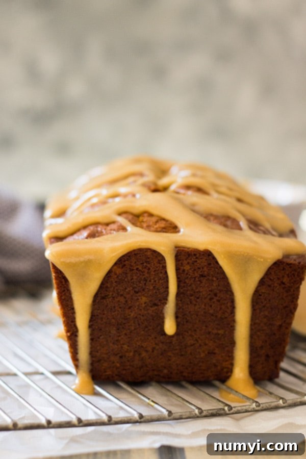 Close-up of the delicious cream cheese caramel icing being drizzled over pumpkin bread