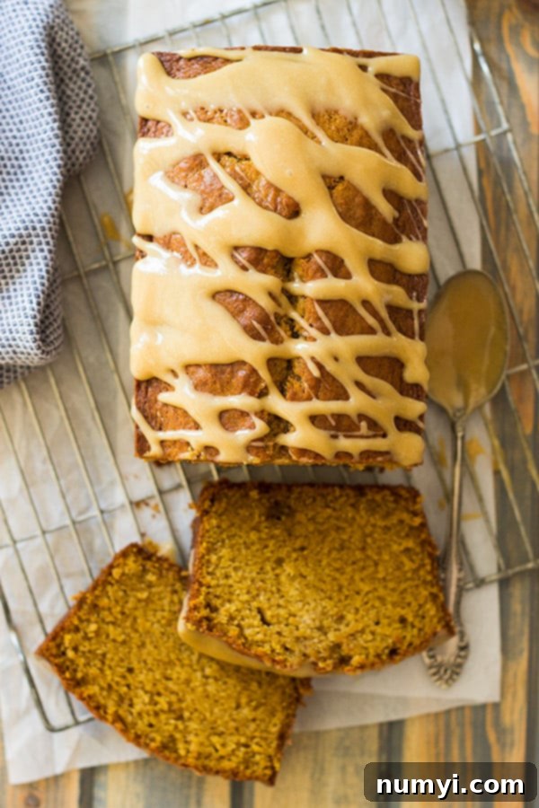 Un-iced pumpkin bread loaf cooling on a wire rack, ready for icing