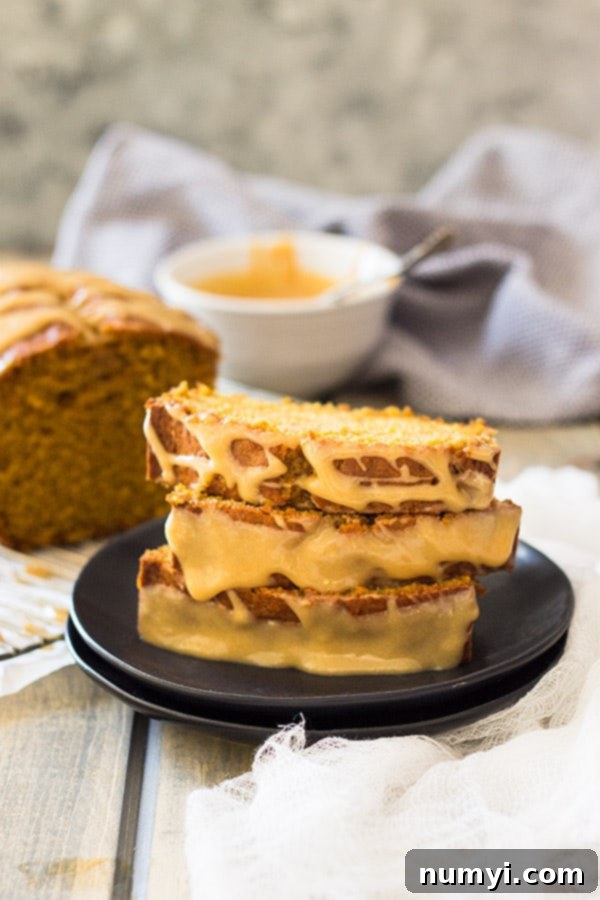 Baked pumpkin bread loaves in metal loaf pans, fresh from the oven