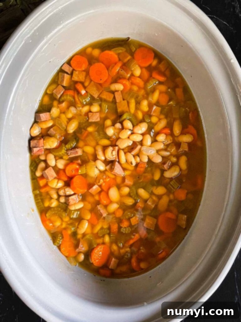 Ham and bean soup simmering in a slow cooker.