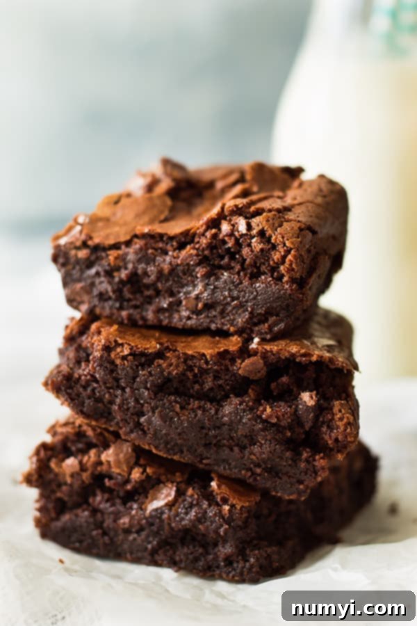 Perfect Homemade Chewy Brownies 5 Multiple squares of homemade chewy brownies stacked enticingly, emphasizing their thick, decadent appearance.