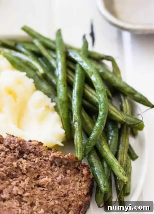 plate with green beans and mashed potatoes