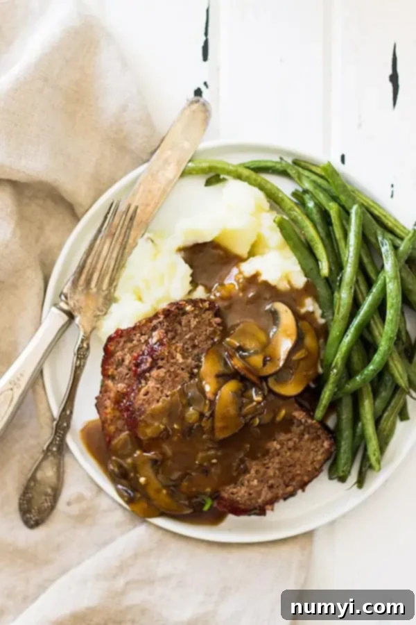 overhead shot of plate with green beans and meatloaf