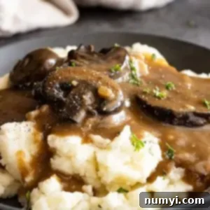 Close up of gravy over mashed potatoes.
