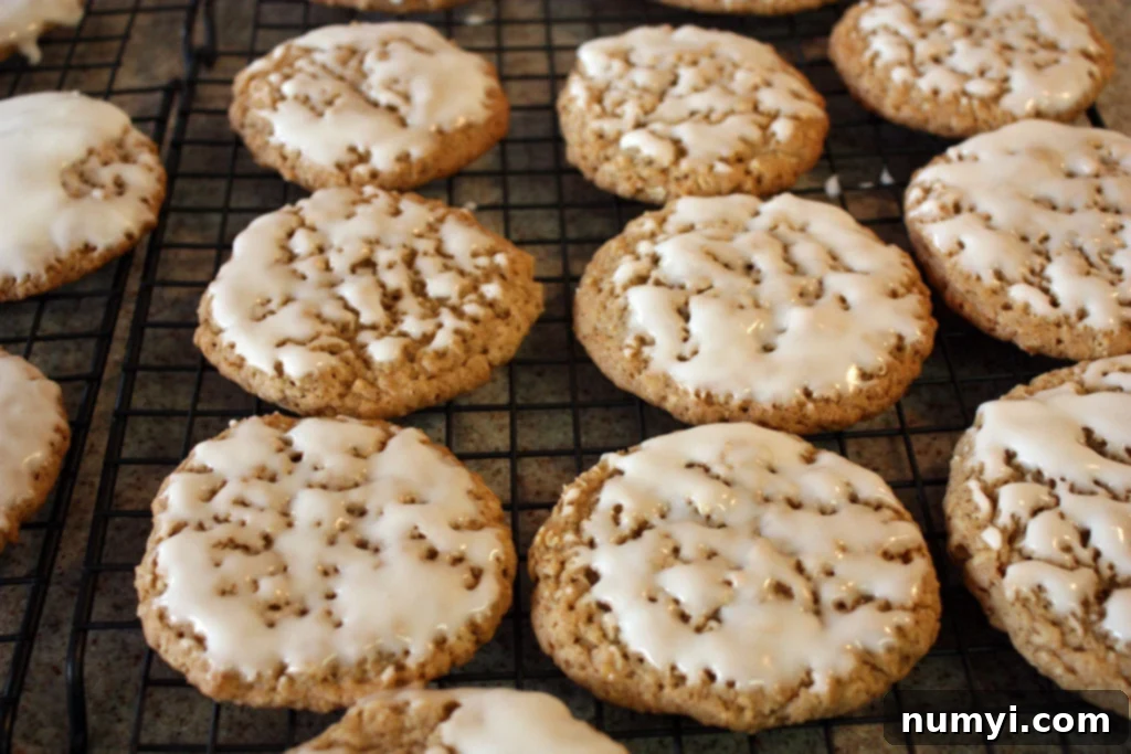 Iced Oatmeal Cookies on a wire rack.