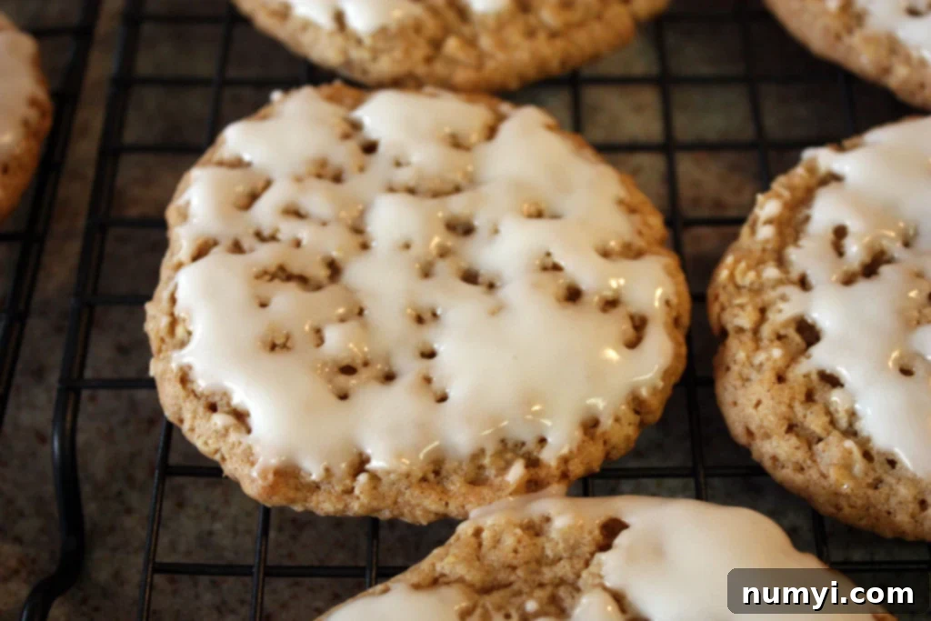 Iced Oatmeal Cookies on a wire rack.