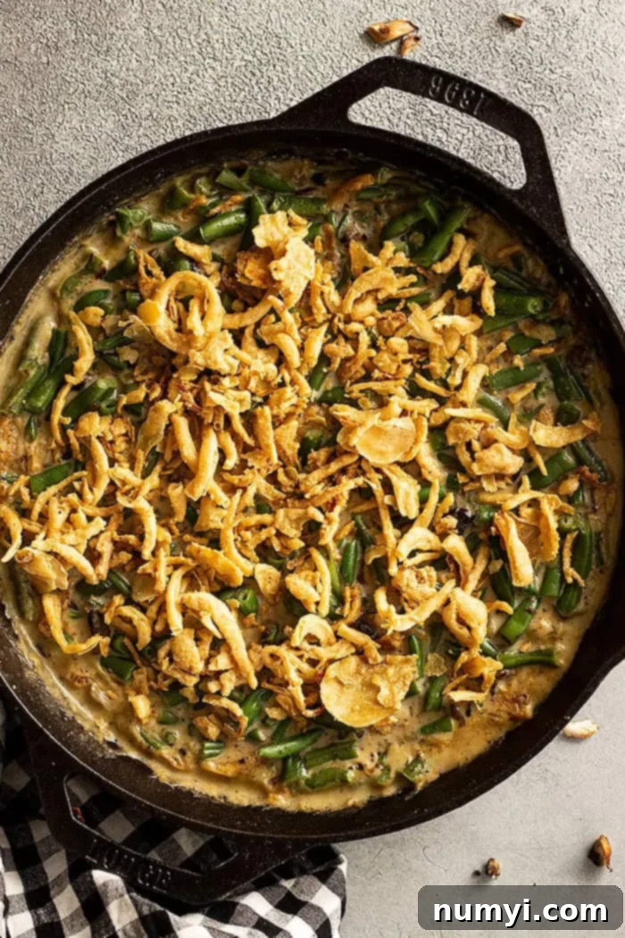 Skillet of Green Bean Casserole with crispy fried onion topping. 