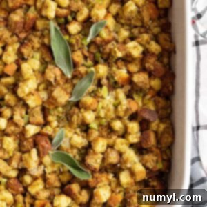 Top down view of freshly baked homemade herb stuffing garnished with fresh sage leaves.