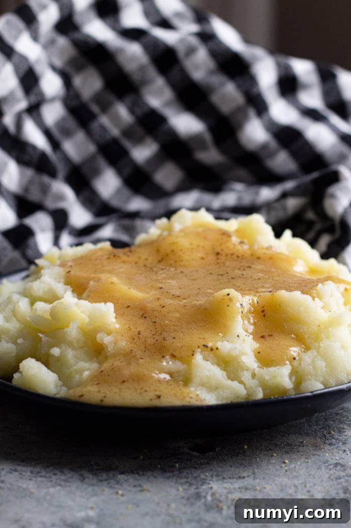 Perfect Homemade Turkey Gravy 4 Homemade turkey gravy poured over mashed potatoes and topped with black pepper.