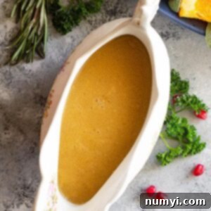 Perfect Homemade Turkey Gravy 6 Homemade turkey gravy in a gravy boat. Fresh herbs and pomegranate seeds scattered around as decoration.