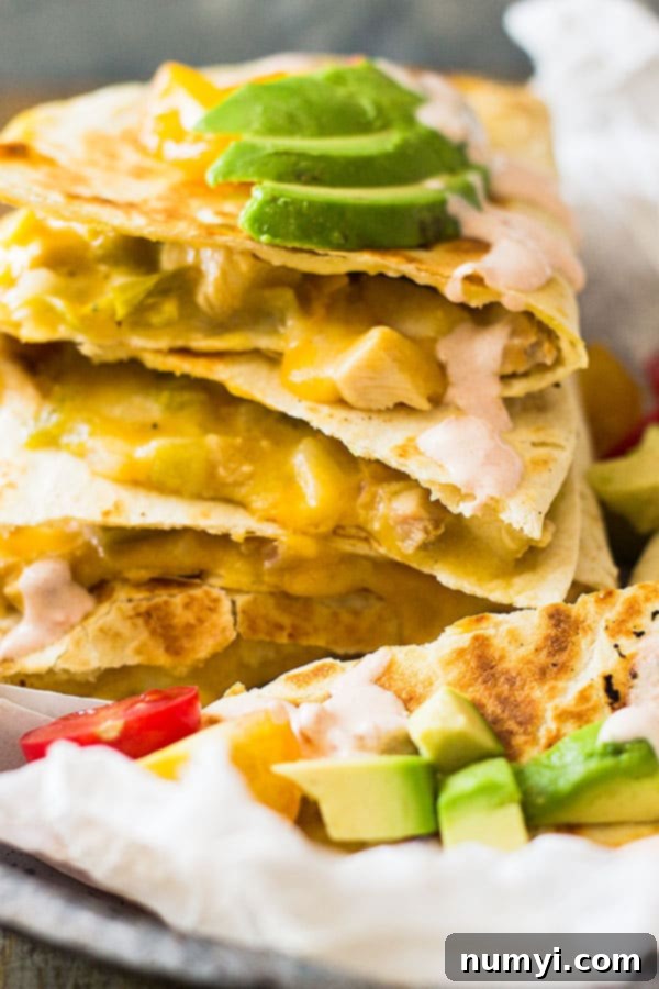 Finished Green Chile Turkey Quesadillas sliced and ready to serve with toppings