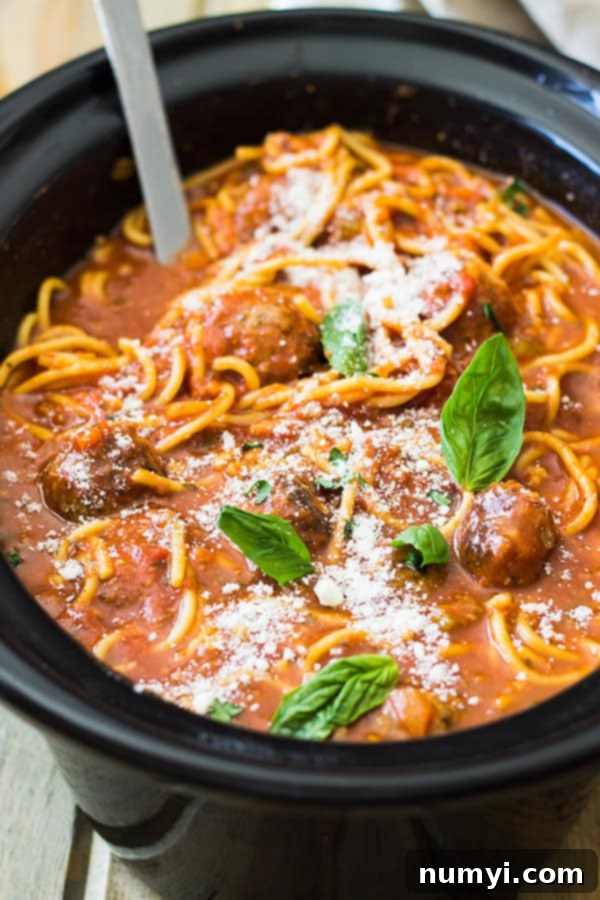 Slow Cooker Spaghetti Meatball Soup: Comforting tomato soup with flavorful meatballs and tender spaghetti